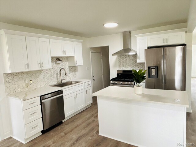 26046 Eureka Dr, Warren, MI 48091 - kitchen with stainless steel appliances, wall chimney exhaust hood, backsplash, and white cabinets
