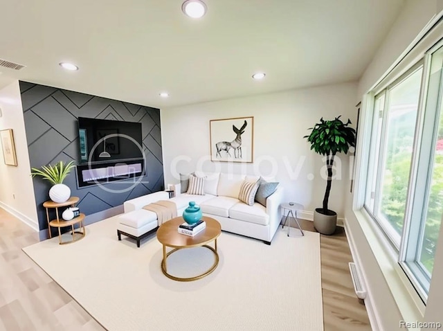 26046 Eureka Dr, Warren, MI 48091 - living room featuring recessed lighting, light wood-style floors, and an accent wall