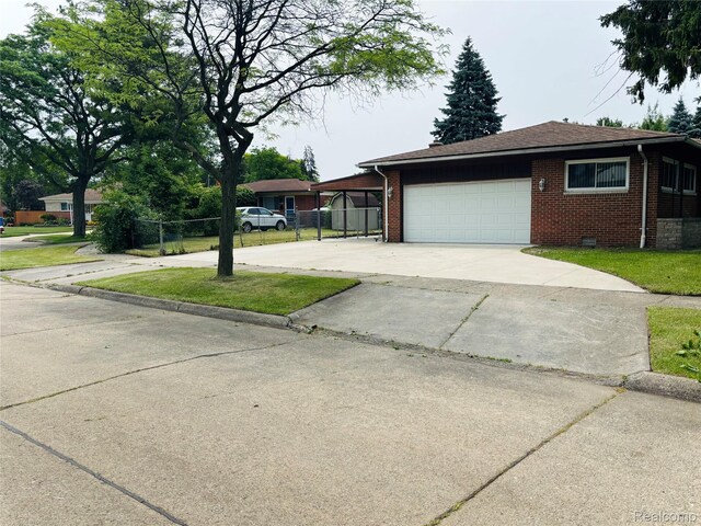 26046 Eureka Dr, Warren, MI 48091 - view of front facade with brick siding, driveway, and a garage