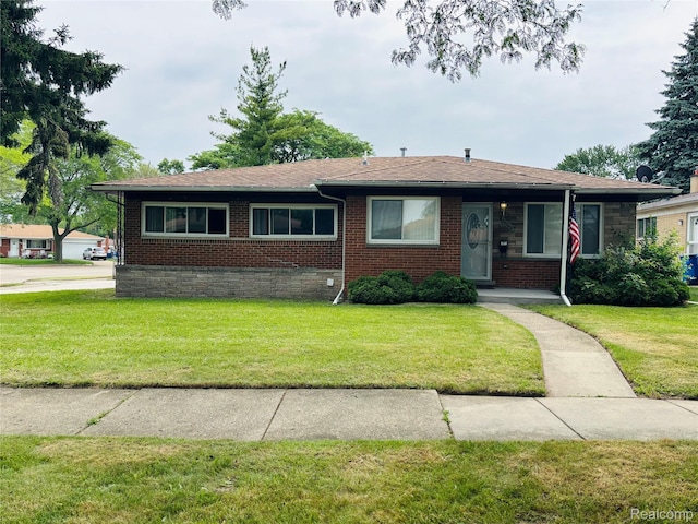 26046 Eureka Dr, Warren, MI 48091 - bungalow featuring a front yard, brick siding, and a shingled roof