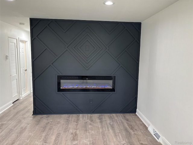 26046 Eureka Dr, Warren, MI 48091 - detailed view of a decorative wall, wood finished floors, and recessed lighting