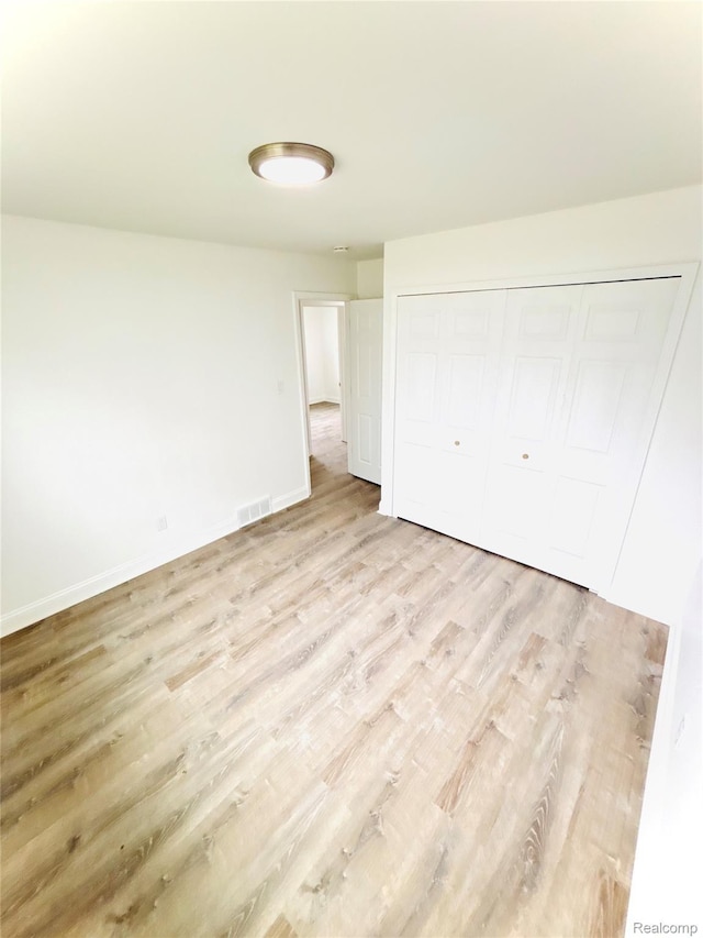 26046 Eureka Dr, Warren, MI 48091 - unfurnished bedroom with light wood finished floors and a closet