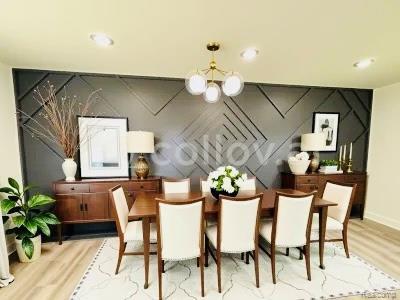 26046 Eureka Dr, Warren, MI 48091 - dining area with a chandelier, wood finished floors, and an accent wall