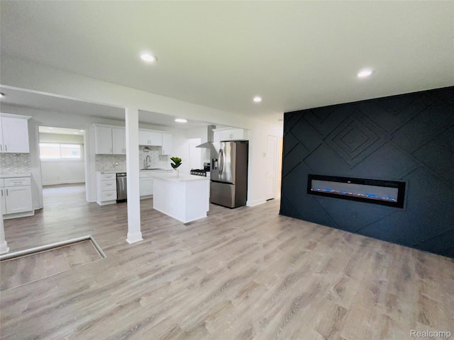 26046 Eureka Dr, Warren, MI 48091 - unfurnished living room featuring light wood finished floors, a fireplace, and recessed lighting