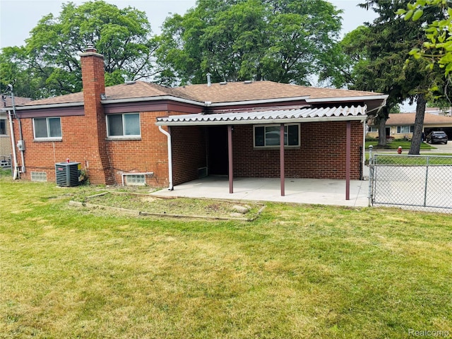 26046 Eureka Dr, Warren, MI 48091 - back of property featuring a chimney, brick siding, a patio, and roof with shingles