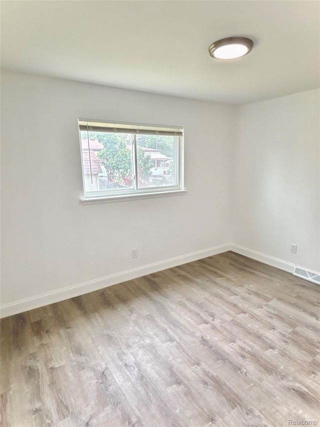 26046 Eureka Dr, Warren, MI 48091 - spare room with wood finished floors and baseboards