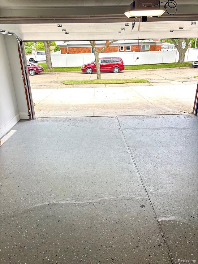 26046 Eureka Dr, Warren, MI 48091 - garage featuring a garage door opener and baseboards