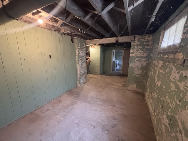 1407 Michigan Ave, Alma, MI 48801 - unfinished below grade area with washer / dryer and wooden walls