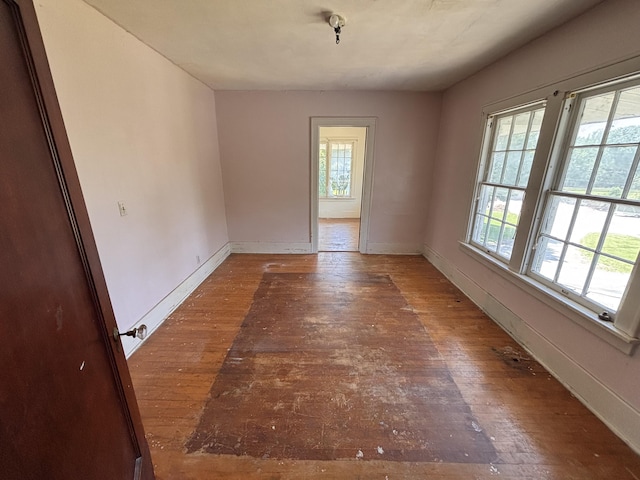 1407 Michigan Ave, Alma, MI 48801 - spare room featuring wood-type flooring and baseboards