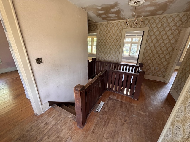 1407 Michigan Ave, Alma, MI 48801 - staircase featuring hardwood / wood-style floors, wallpapered walls, and ornamental molding