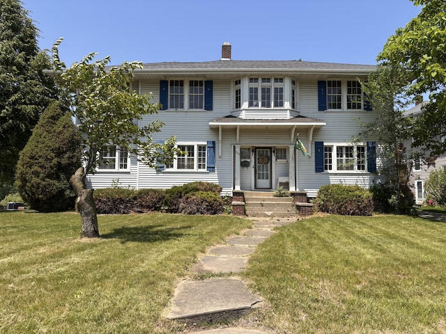 1407 Michigan Ave, Alma, MI 48801 - view of front of house featuring a front yard and a chimney