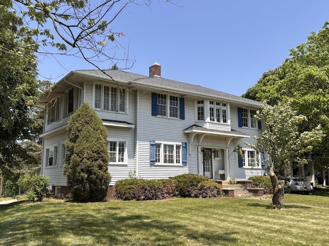 1407 Michigan Ave, Alma, MI 48801 - colonial inspired home featuring a chimney and a front lawn