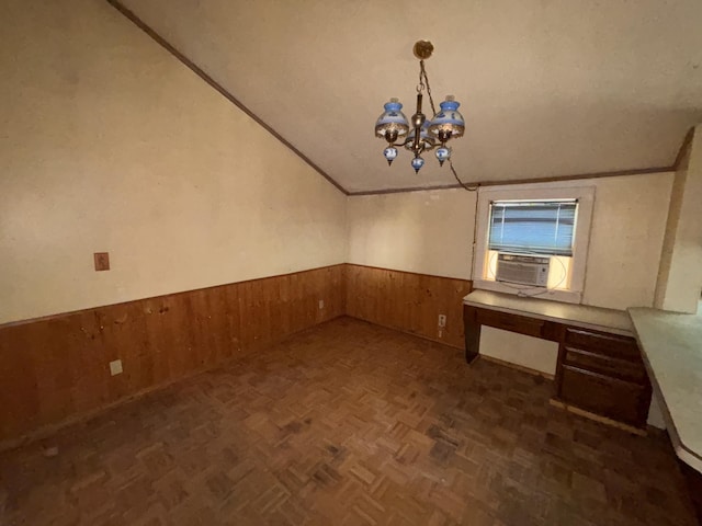 1407 Michigan Ave, Alma, MI 48801 - unfurnished dining area featuring lofted ceiling, cooling unit, wainscoting, a chandelier, and wooden walls