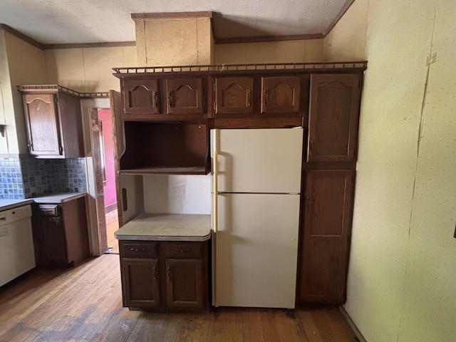 1407 Michigan Ave, Alma, MI 48801 - kitchen with white appliances, ornamental molding, light wood finished floors, a textured ceiling, and decorative backsplash