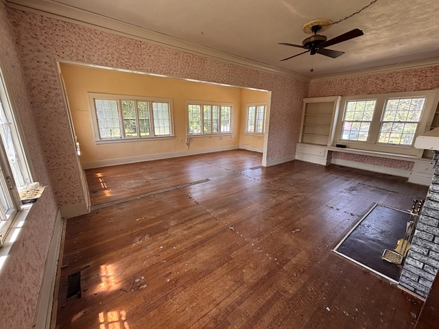 1407 Michigan Ave, Alma, MI 48801 - unfurnished living room featuring hardwood / wood-style flooring, wallpapered walls, healthy amount of natural light, ornamental molding, and a ceiling fan