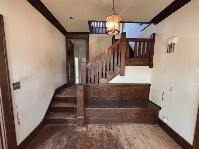 1407 Michigan Ave, Alma, MI 48801 - staircase with ornamental molding, a chandelier, and wood finished floors