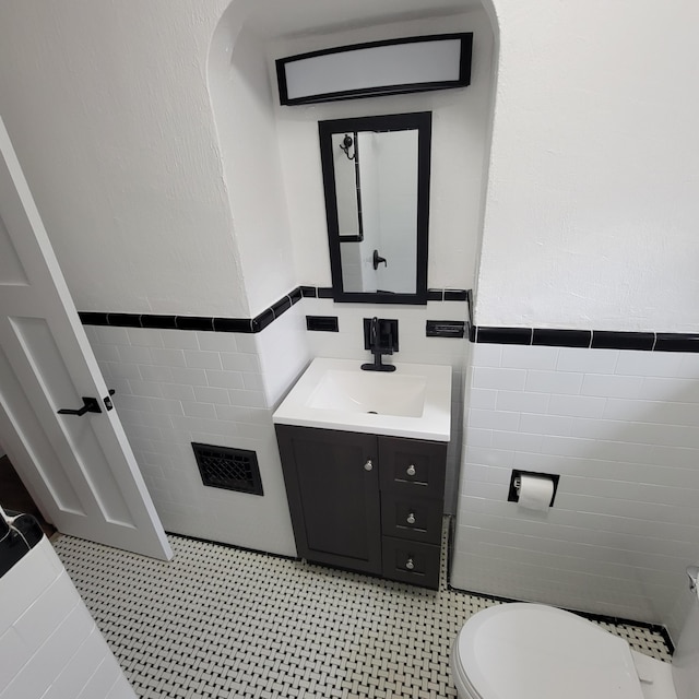 2356 SE Paris, Grand Rapids, MI 49507 - bathroom featuring tile walls, vanity, and wainscoting