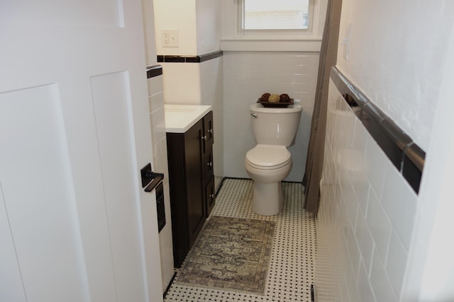 2356 SE Paris, Grand Rapids, MI 49507 - bathroom with vanity, tile walls, and wainscoting