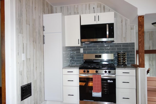 2356 SE Paris, Grand Rapids, MI 49507 - kitchen with stainless steel appliances, white cabinets, backsplash, and light stone counters