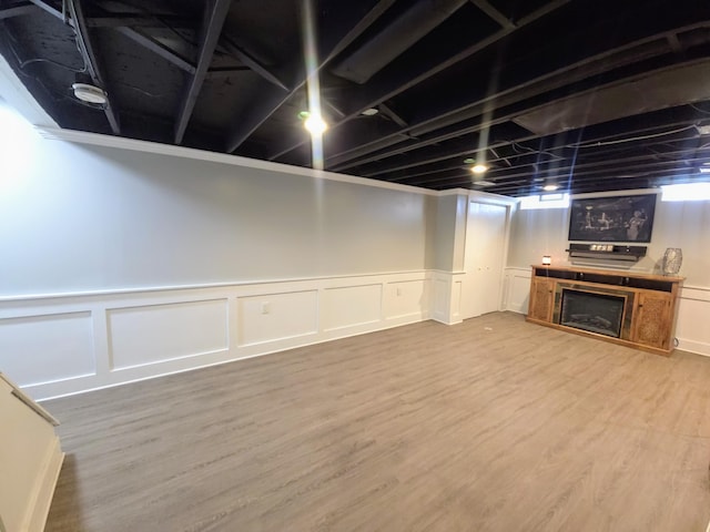 24825 Timber Ridge Trl, Flat Rock, MI 48134 - finished below grade area with a decorative wall, wood finished floors, a fireplace, and wainscoting
