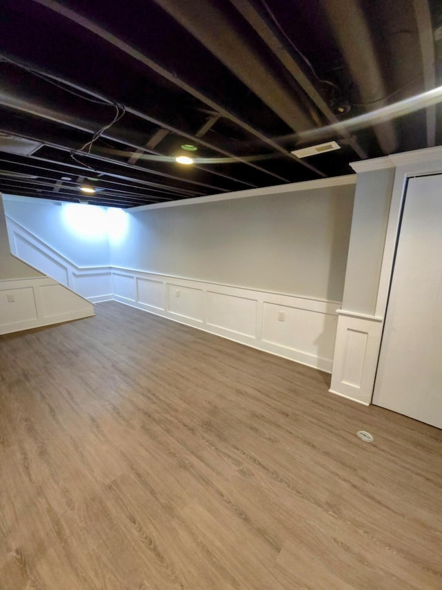 24825 Timber Ridge Trl, Flat Rock, MI 48134 - finished below grade area featuring a wainscoted wall, a decorative wall, and wood finished floors