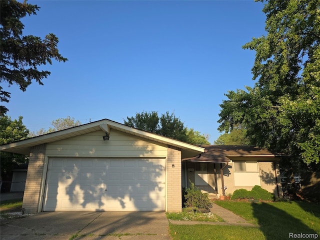 21450 Evergreen Rd, Southfield, MI 48075 - ranch-style house featuring brick siding, concrete driveway, and an attached garage