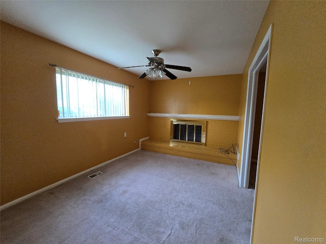 21450 Evergreen Rd, Southfield, MI 48075 - unfurnished living room featuring carpet, a brick fireplace, and a ceiling fan