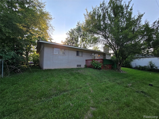 21450 Evergreen Rd, Southfield, MI 48075 - rear view of property with brick siding, a deck, and a yard