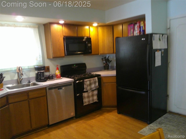 20329 Churchill Ave, Trenton, MI 48183 - kitchen featuring black appliances, light countertops, brown cabinets, and light wood finished floors