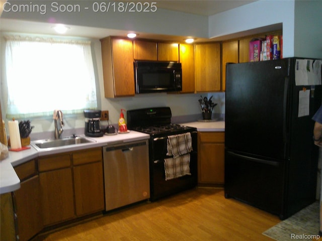 20329 Churchill Ave, Trenton, MI 48183 - kitchen with black appliances, light countertops, light wood-style flooring, and brown cabinetry