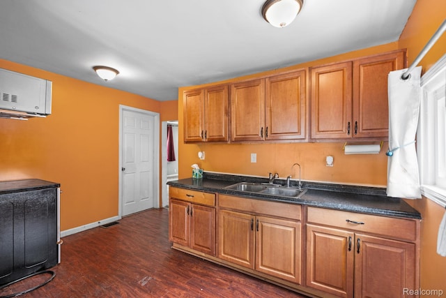 2263 Overridge Ave, Waterford, MI 48327 - kitchen with brown cabinets, dark countertops, dark wood finished floors, and a wall mounted air conditioner