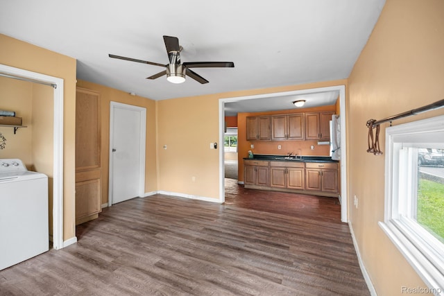 2263 Overridge Ave, Waterford, MI 48327 - unfurnished living room featuring washer / clothes dryer, a ceiling fan, plenty of natural light, and dark wood finished floors