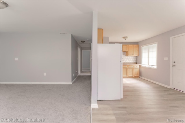 853 Melrose St, Pontiac, MI 48340 - kitchen with light brown cabinets, freestanding refrigerator, decorative backsplash, light countertops, and light wood-type flooring
