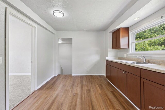3140 Moore St, Inkster, MI 48141 - kitchen featuring light wood finished floors, a textured ceiling, and light countertops