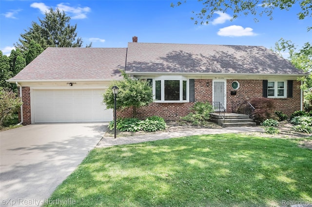 517 S Scott St, Adrian, MI 49221 - view of front facade with driveway, an attached garage, brick siding, a front yard, and roof with shingles