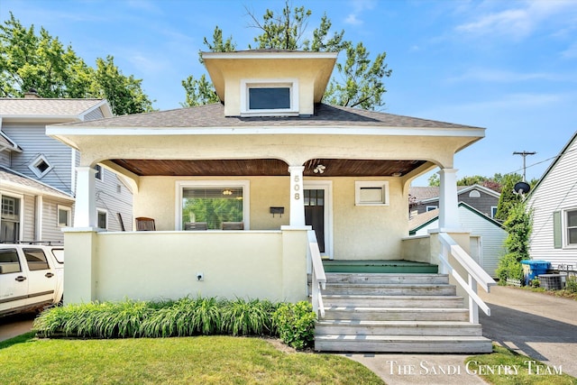 508 Fulton St, Grand Haven, MI 49417 - bungalow with covered porch, stucco siding, and roof with shingles