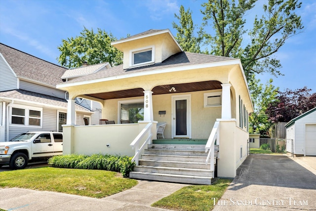508 Fulton St, Grand Haven, MI 49417 - view of front of home featuring covered porch, stucco siding, and a shingled roof
