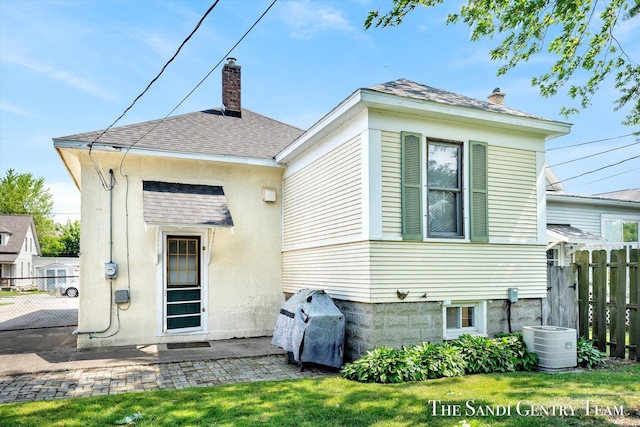 508 Fulton St, Grand Haven, MI 49417 - rear view of property featuring a chimney and a shingled roof