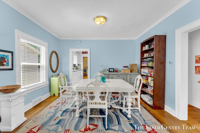 508 Fulton St, Grand Haven, MI 49417 - dining room with light wood finished floors and ornamental molding