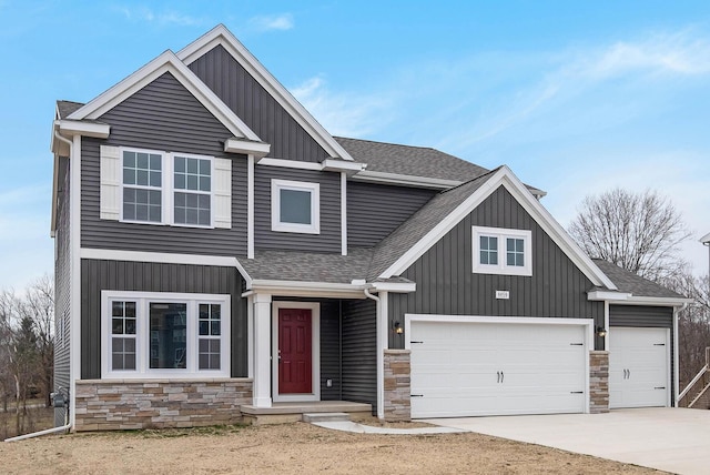7946 Snow View Dr SE, Alto, MI 49302 - view of front facade with roof with shingles, a garage, stone siding, concrete driveway, and board and batten siding