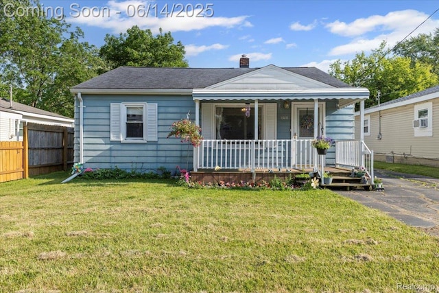 1386 Proper Ave, Burton, MI 48529 - view of front facade featuring covered porch, a chimney, and a shingled roof