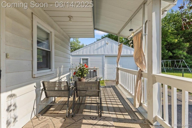 1386 Proper Ave, Burton, MI 48529 - wooden deck featuring an outbuilding and a garage