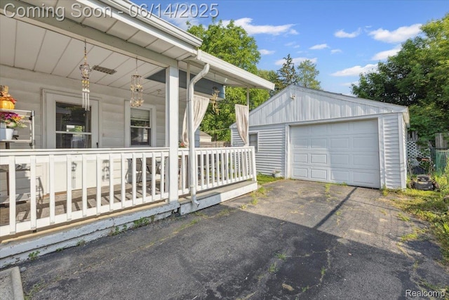 1386 Proper Ave, Burton, MI 48529 - detached garage featuring a porch and asphalt driveway
