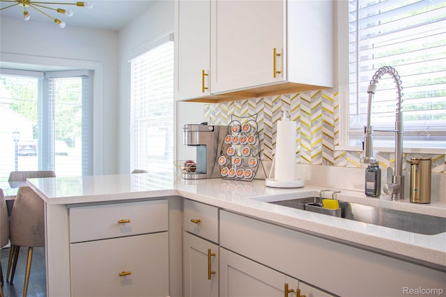 21110 Van Buren St, Southfield, MI 48033 - kitchen featuring tasteful backsplash, a peninsula, and white cabinets