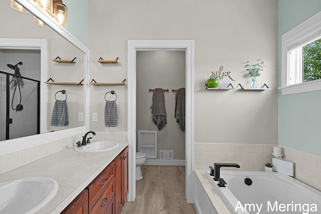 1824 Restoration Dr SW, Byron Center, MI 49315 - bathroom featuring double vanity, a bath, tiled shower, and wood finished floors