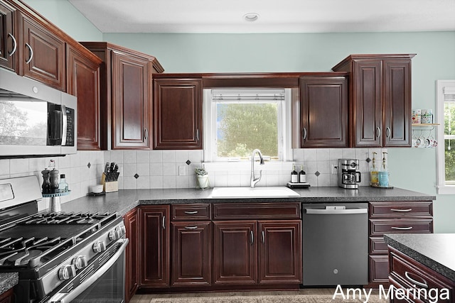 1824 Restoration Dr SW, Byron Center, MI 49315 - kitchen with appliances with stainless steel finishes, dark countertops, decorative backsplash, and healthy amount of natural light