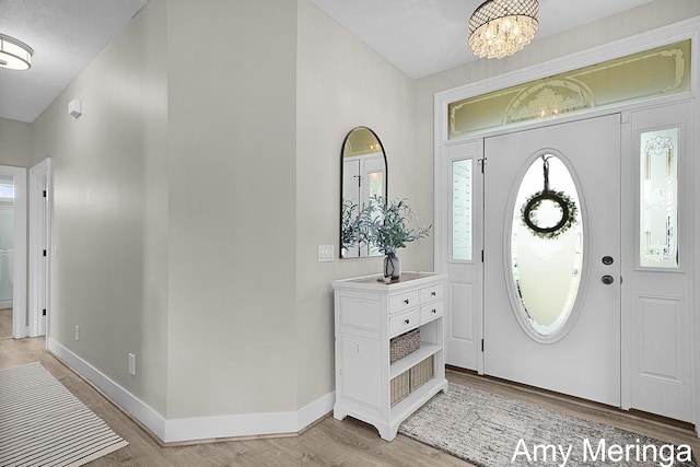 1824 Restoration Dr SW, Byron Center, MI 49315 - foyer with light wood-type flooring and a chandelier