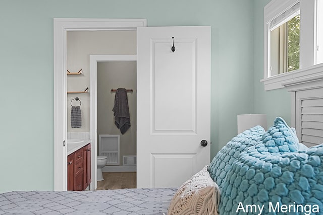 1824 Restoration Dr SW, Byron Center, MI 49315 - bedroom with ensuite bath and wood finished floors