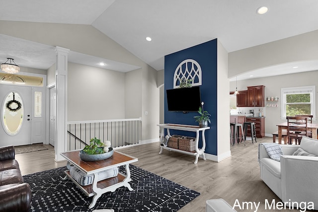 1824 Restoration Dr SW, Byron Center, MI 49315 - living room featuring light wood-style floors, vaulted ceiling, recessed lighting, and arched walkways