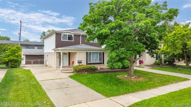 29656 Brentwood St, Southfield, MI 48076 - view of front of property featuring brick siding, a front lawn, and a porch
